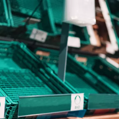 Empty green plastic fruit and vegetable punnets in supermarket shelves