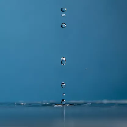 Trickle of water on blue background