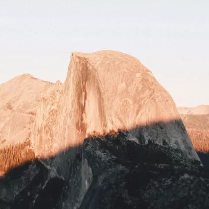 Dry rocky mountain landscape with clear sky and dark shadow